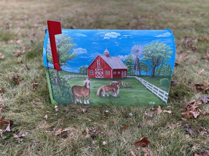 A custom mailbox with painted farm scene