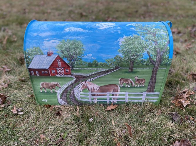 A custom mailbox with painted farm scene